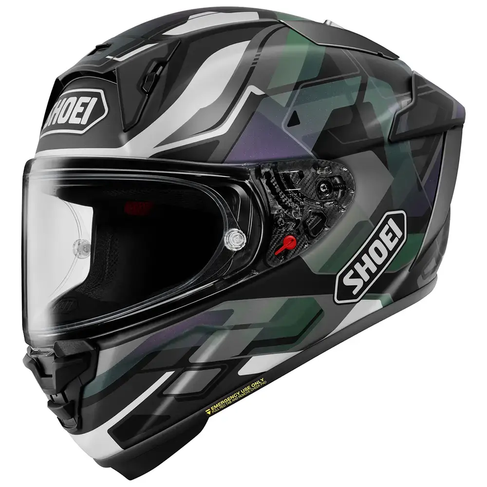Casco integral Shoei con patrón camuflaje en tonos negro, gris y verde. Visor transparente y ventilación superior. Logotipo Shoei visible.