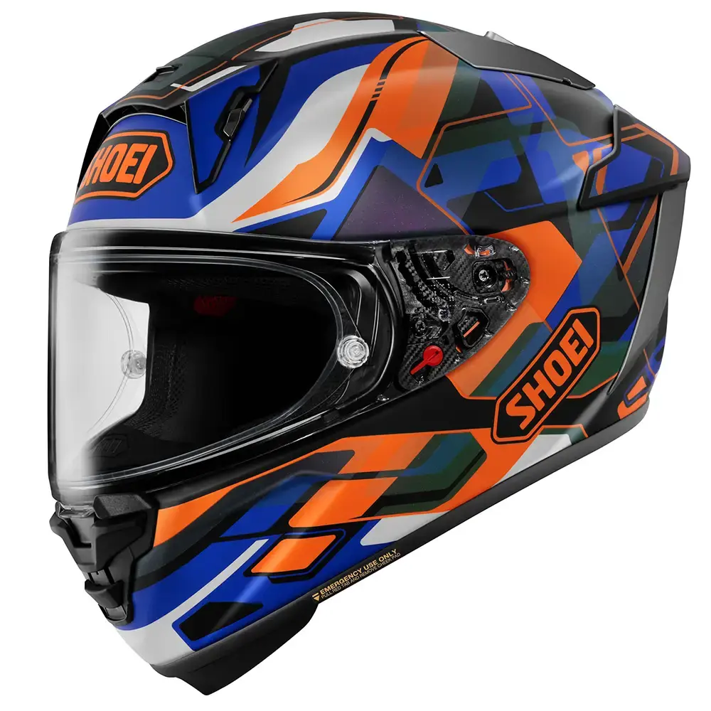 Casco integral Shoei con diseño geométrico multicolor en azul, naranja, negro, blanco y verde, con visera transparente y ventilaciones.